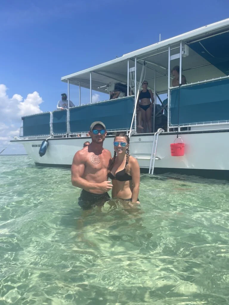 crab island charter fort walton beach fl people standing in water at crab island next to bikkini bottom boat from beach please charters